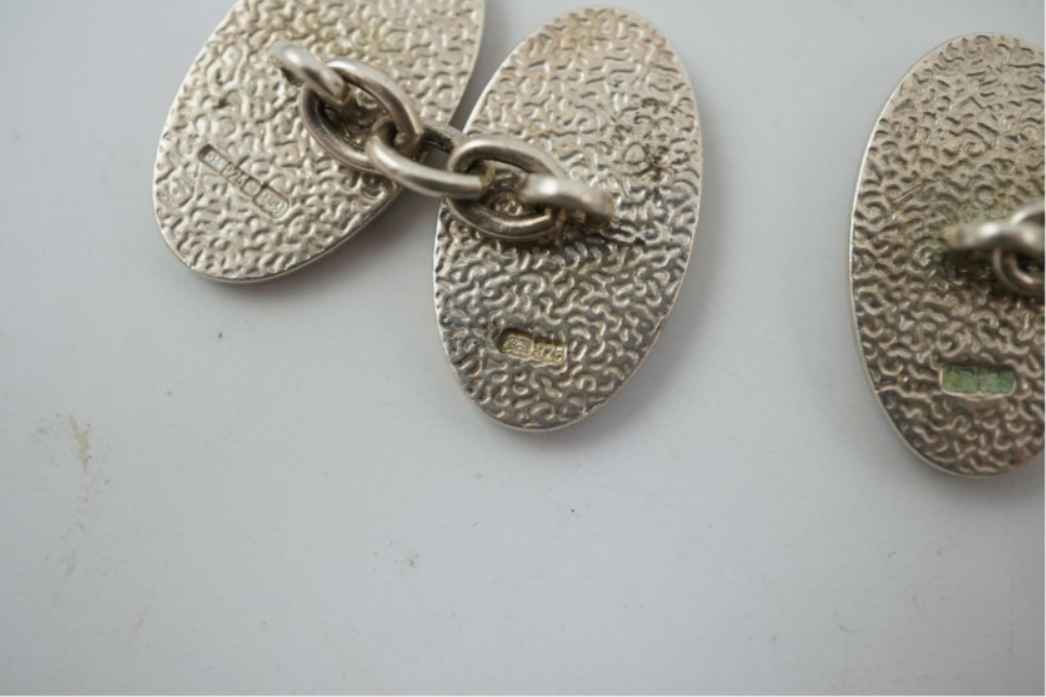 A modern pair of silver and polychrome enamel set oval cufflinks, 18mm.